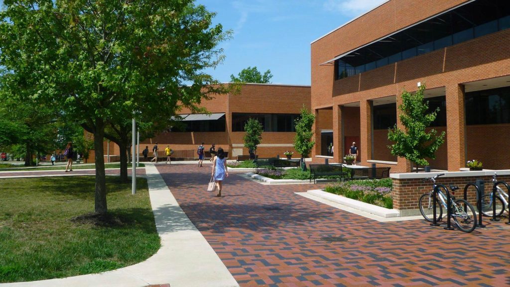 a student walking towards the McClain Hall