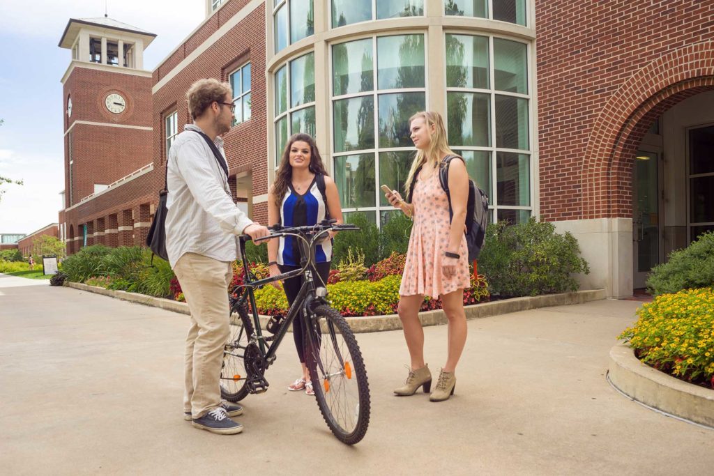 three students walking in front of the pickler memorial library