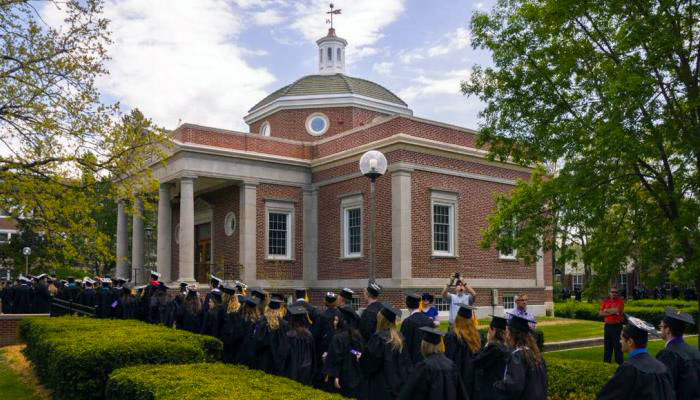 graduates lining up to go into the kirk memorial building