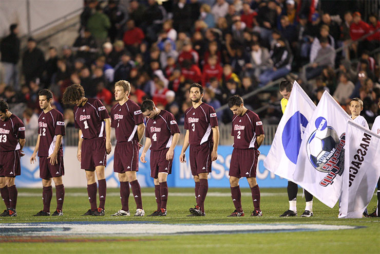 The UMass men's soccer team lined up before the start of a match