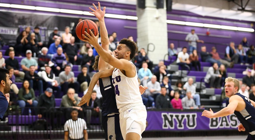 A NYU basketball player contesting for the ball