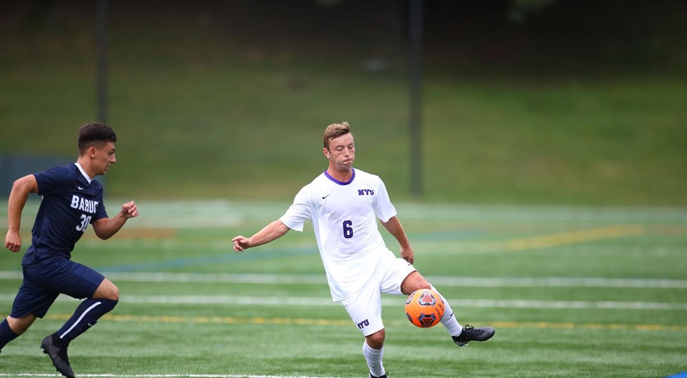 A soccer player dribbling past an opponent
