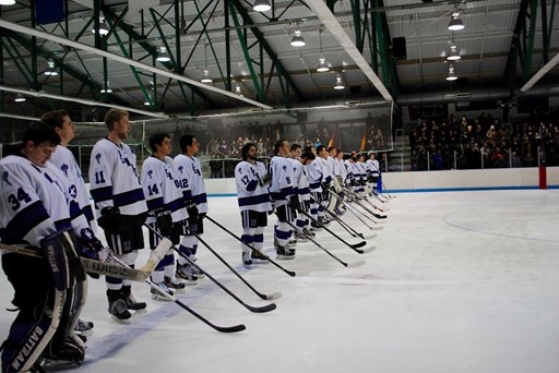 The Ice hockey team posing on the rink