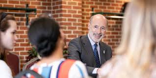 the governor of Pennsylvania with students talking about scholarship plan