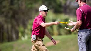 coach giving another person a piece of paper
