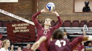 a volleyball player getting read to serve the ball to their teammate