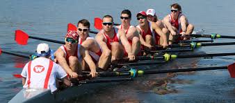 a group of rowing members on the water
