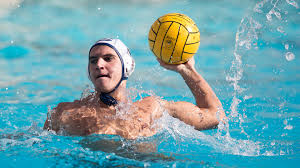 a player holding the ball in the water