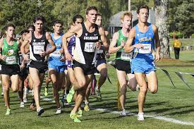 men running on a the grass