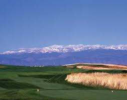 the golf course with the mountains behind