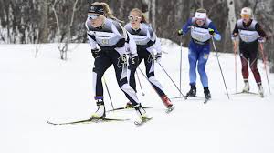 women on the snow with their skiis