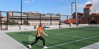 a girl getting ready to hit the tennis ball