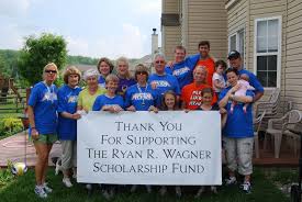 people around a sign raising funds for the ryan r wagner scholarship fund