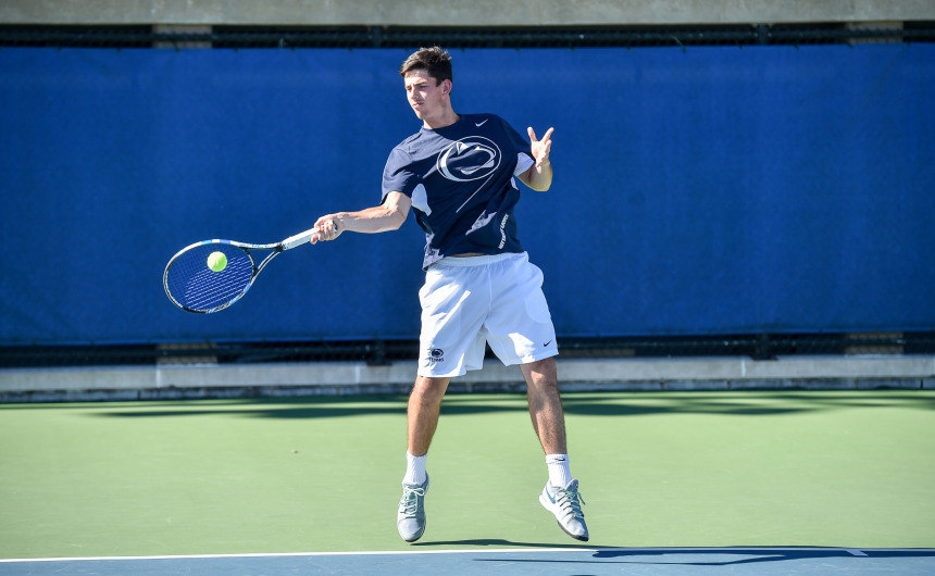 A Penn State student playing in a tennis match