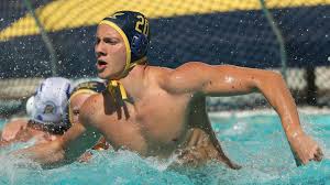 a water polo player diving for the ball