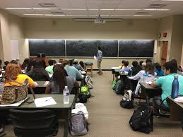 students being taught by a tutor in group tutoring