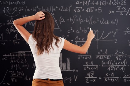 Student solving a math problem on the board.
