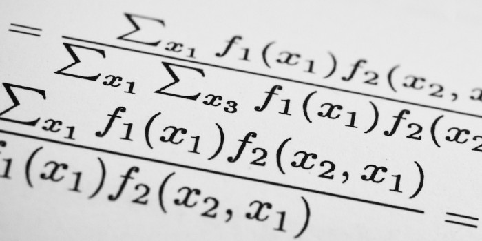 Image of equations on paper.