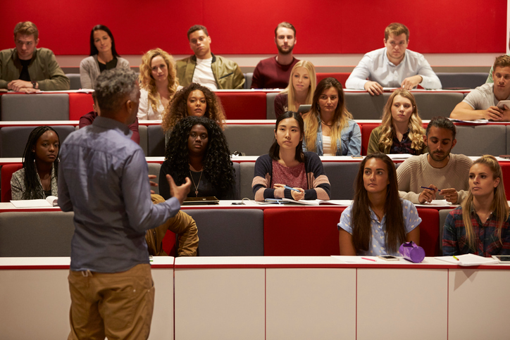 Professor teaching to a lecture hall of students.