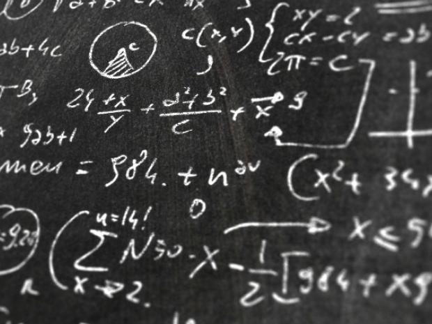 Image of equations on a chalkboard.