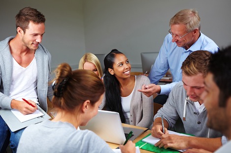 Professor working with a group of students in class.
