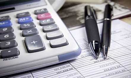 Pen, calculator, and balance sheet