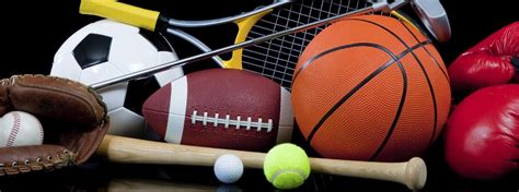 different sports balls and equipment in a pile.
