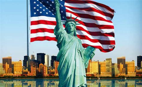 The Statue of Liberty with the American Flag behind it.