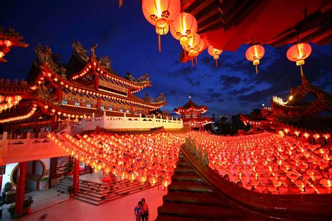A town in China at night with lights on the buildings.